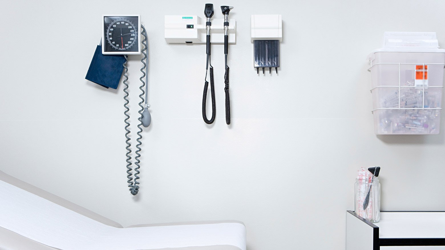 A doctor's examination room with an examination table and equipment