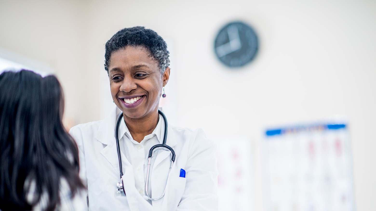 A female doctor provides medical care to a young girl