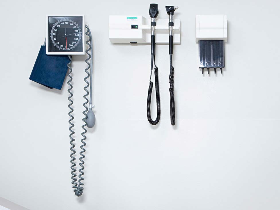 A doctor's examination room with an examination table and equipment