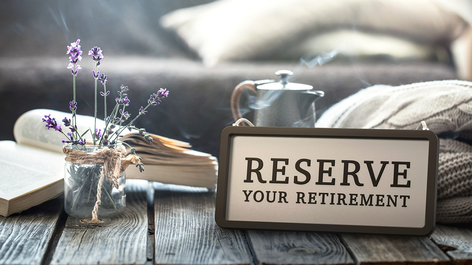 Lavender and a book on a table with a Reserve Your Retirement sign